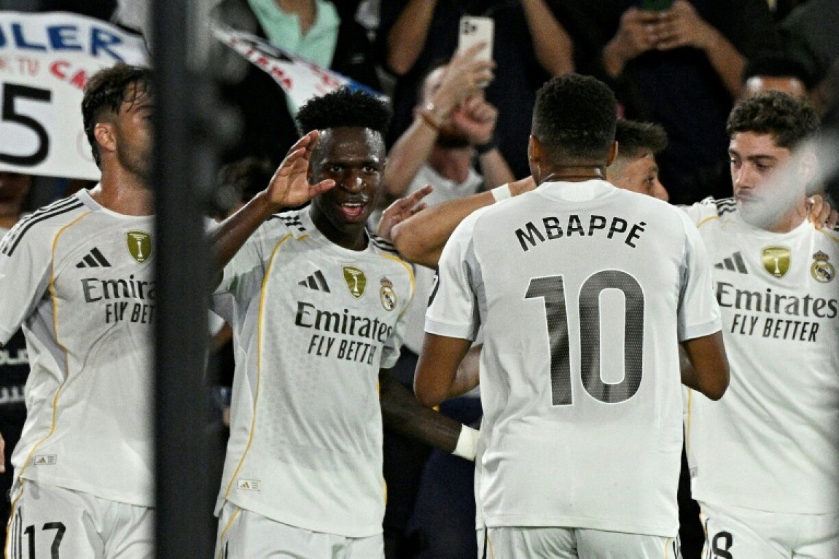 Real Madrid's Brazilian forward Vinicius Junior celebrates with team-mates after scoring his team's first goal in the rout of Levante on Tuesday