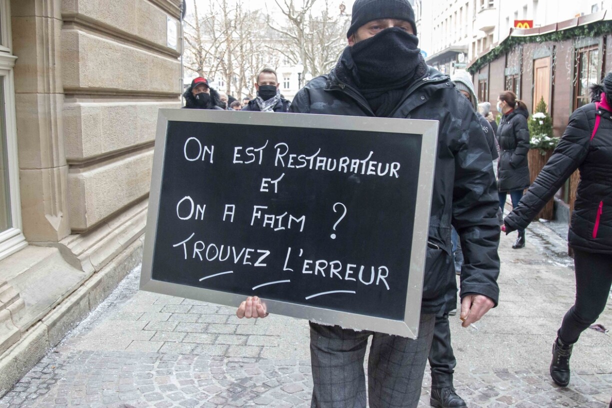 A man holds a sign at the Horesca protest in Luxembourg on Saturday.