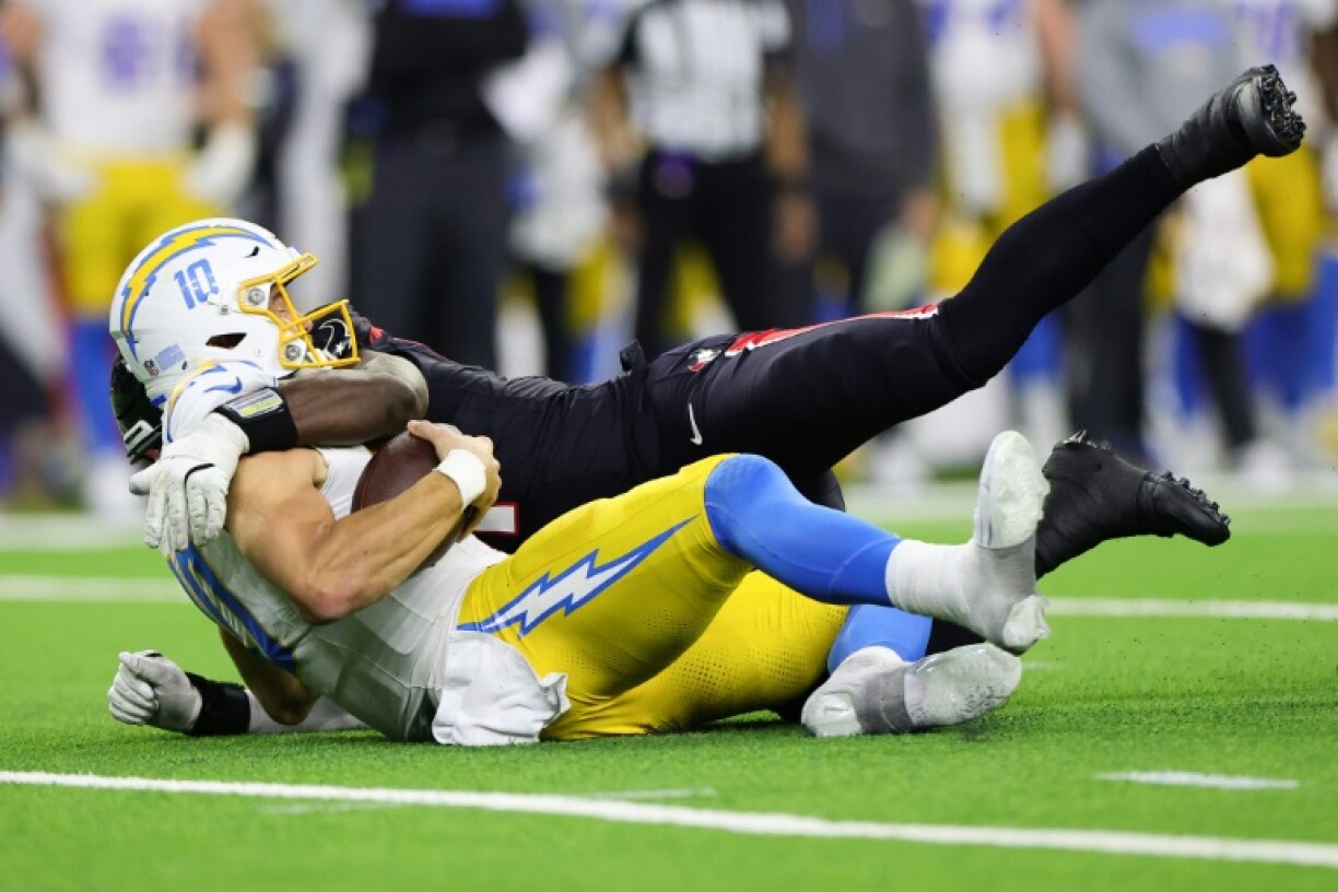 Will Anderson Jr. of the Houston Texans sacks Los Angeles Chargers quarterback Justin Herbert in the Texans' NFL playoff victory over the Chargers