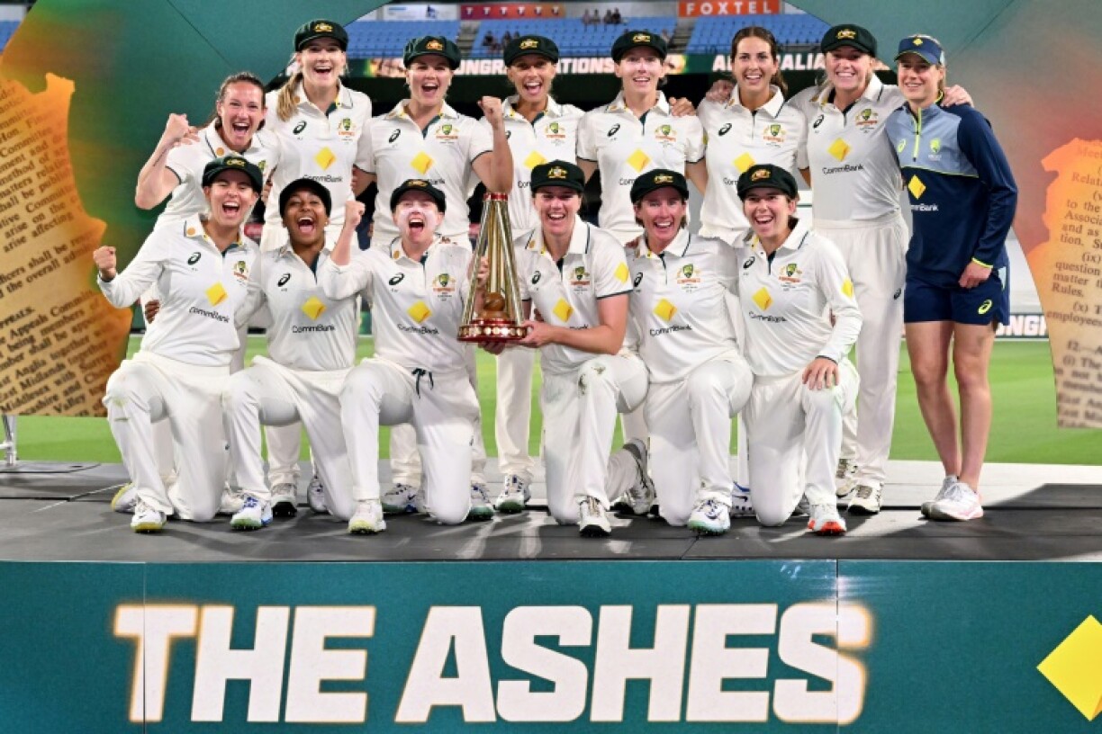 Australia players pose with the trophy after defeating England to complete an Ashes whitewash
