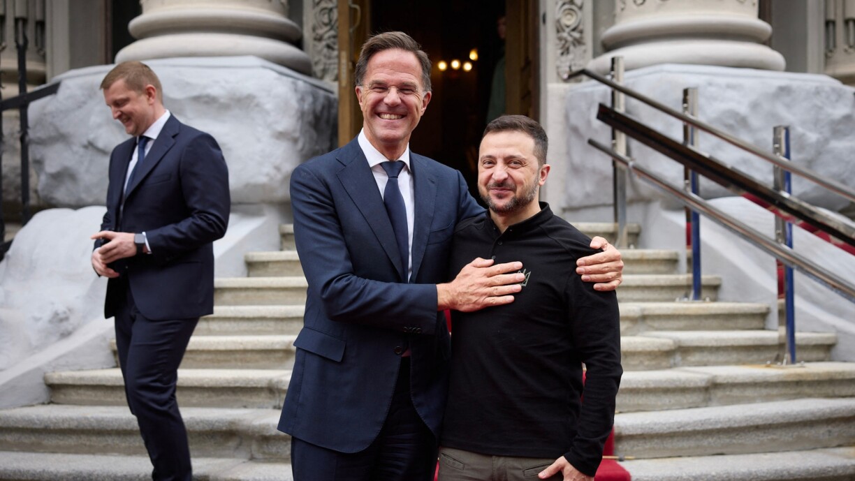 In this handout photograph taken and released by the Ukrainian Presidential Press Service on 3 October Ukraine's President Volodymyr Zelensky (R) and NATO Secretary General Mark Rutte (C) pose for a photo prior to their talks in Kyiv.