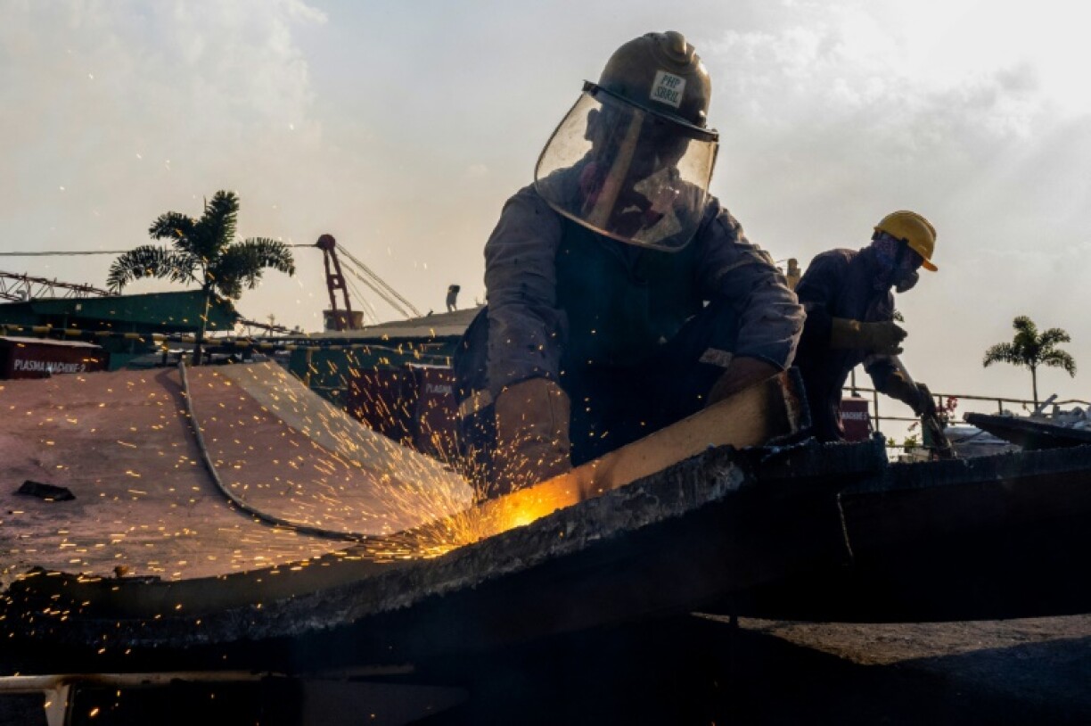Workers cut down metal parts at the PHP shipbreaking yard in Chittagong, the most advanced in the region