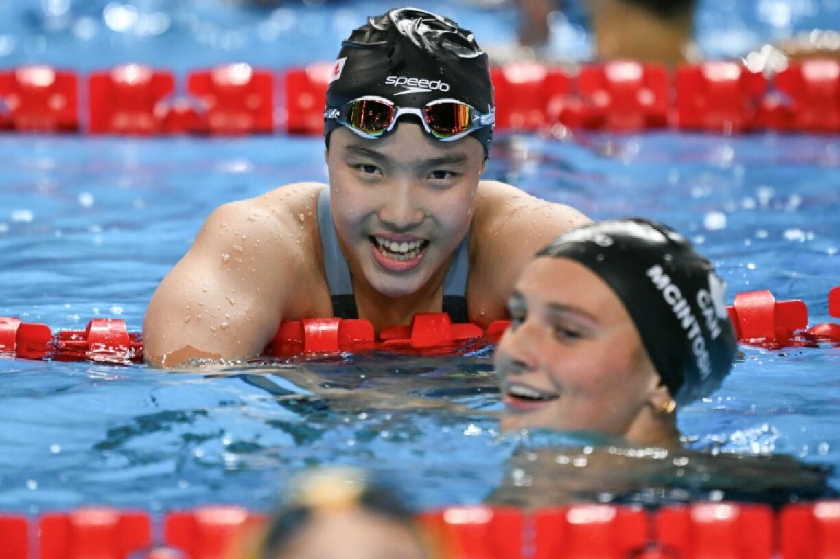 China's 12-year-old Yu Zidi (top) and Canada's Summer Mcintosh after the final of the World Championships 400m individual medley in Singapore. The pair are set for starring roles at LA 2028