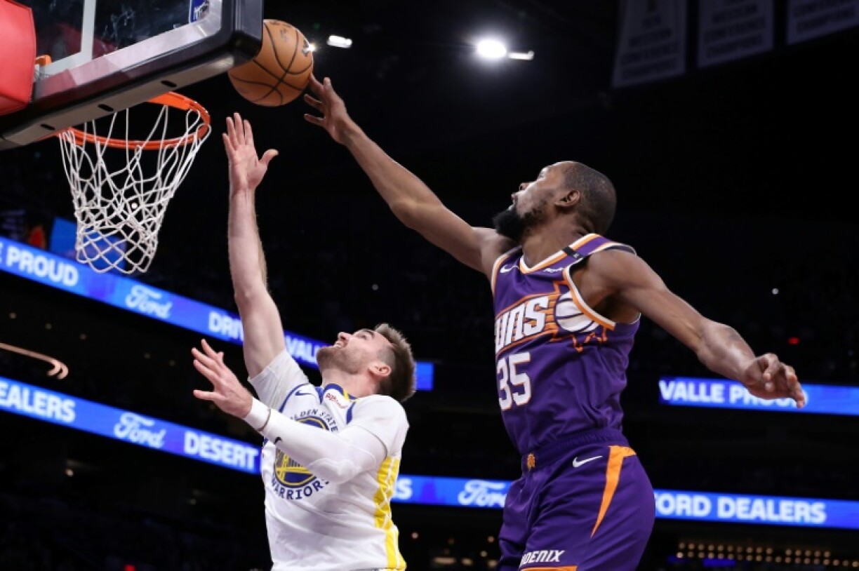Phoenix's Kevin Durant blocks a layup attempt by Golden State's Pat Spencer in the Suns' NBA home victory over the Warriors