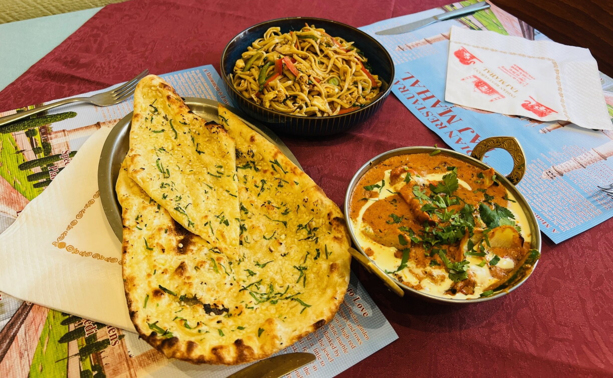 Popular dishes include the lamb rogan josh, butter chicken, garlic naan baked in the tandoor, and in-house biryani.