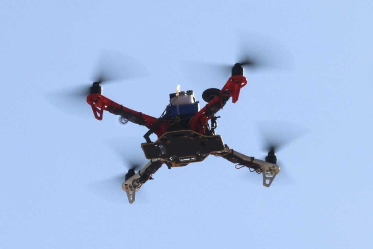 A drone built by engineering students executes a test flight at Iran's Tech Olympics
