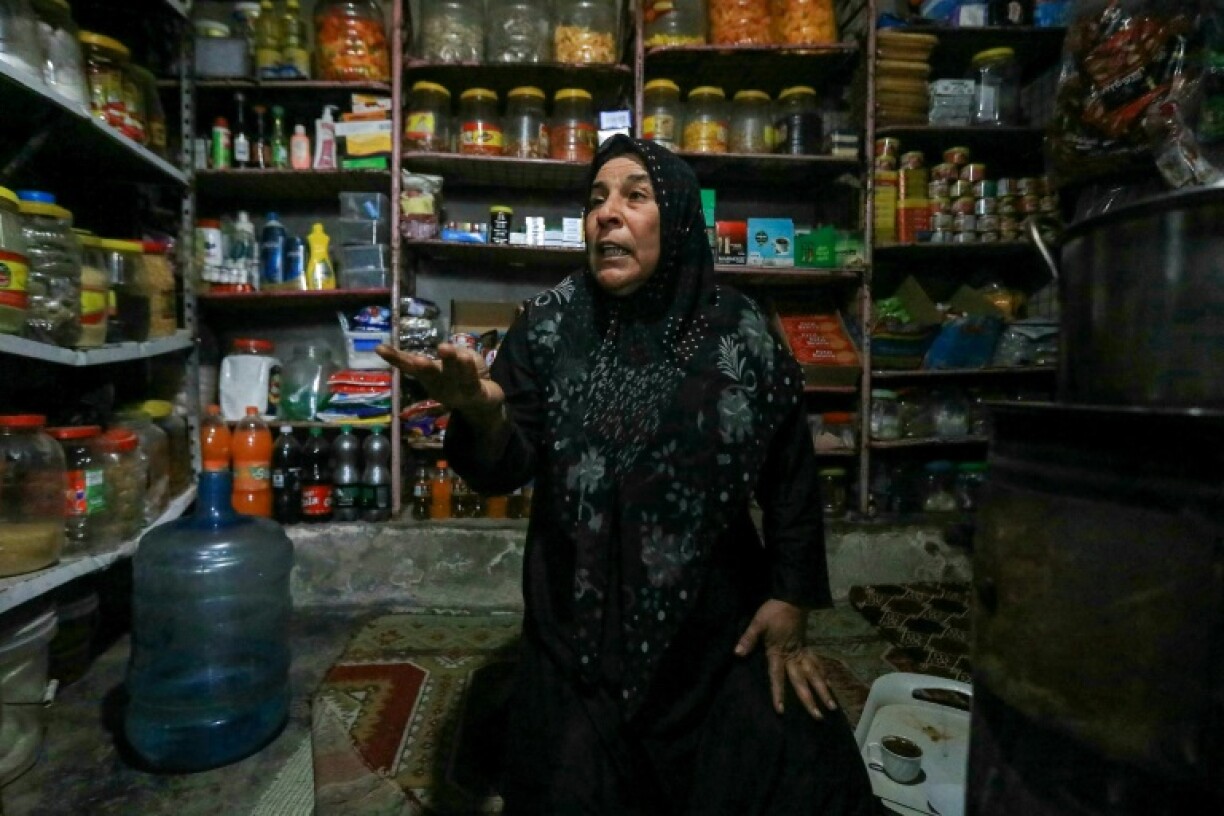 Shelves of foodstuffs line the walls of a shop in the Atme camp
