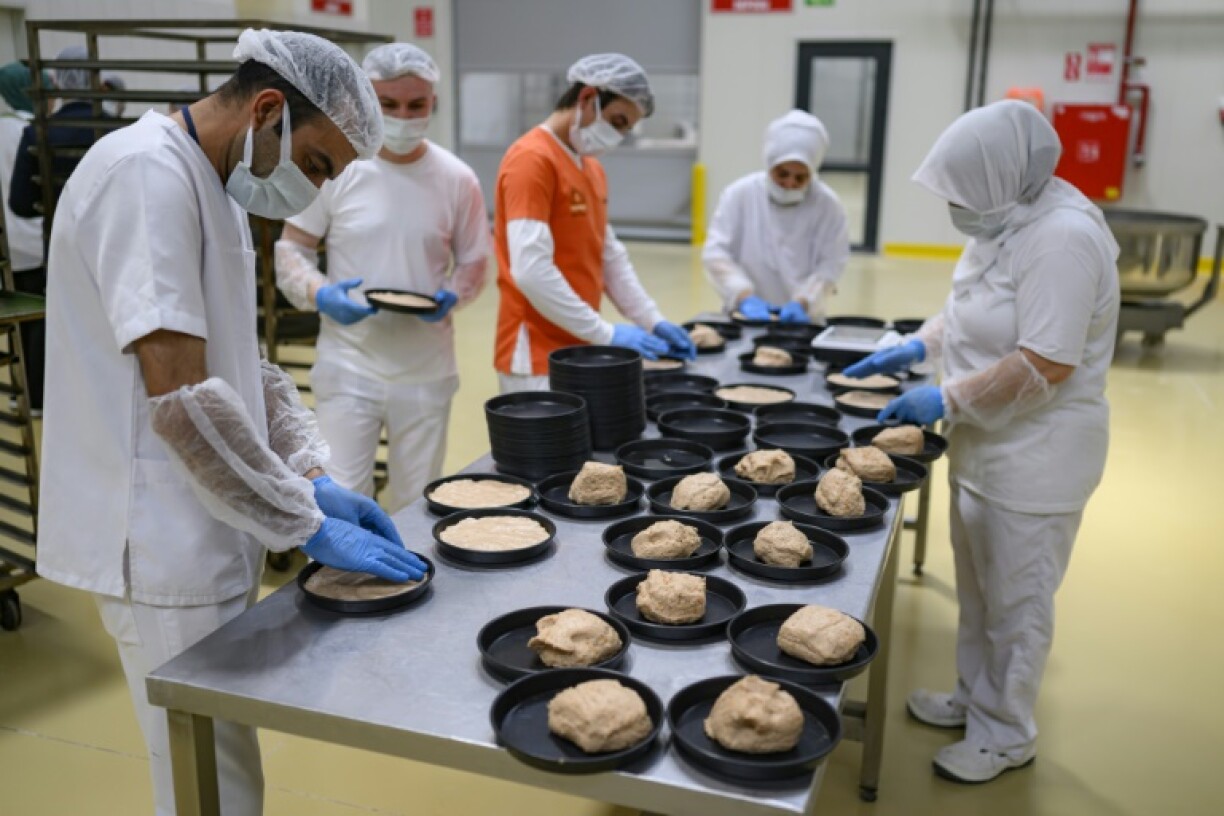 Employees at the Halk Ekmek bakery mix and cut dough for Kulluoba bread, recreating a 5,000-year-old loaf