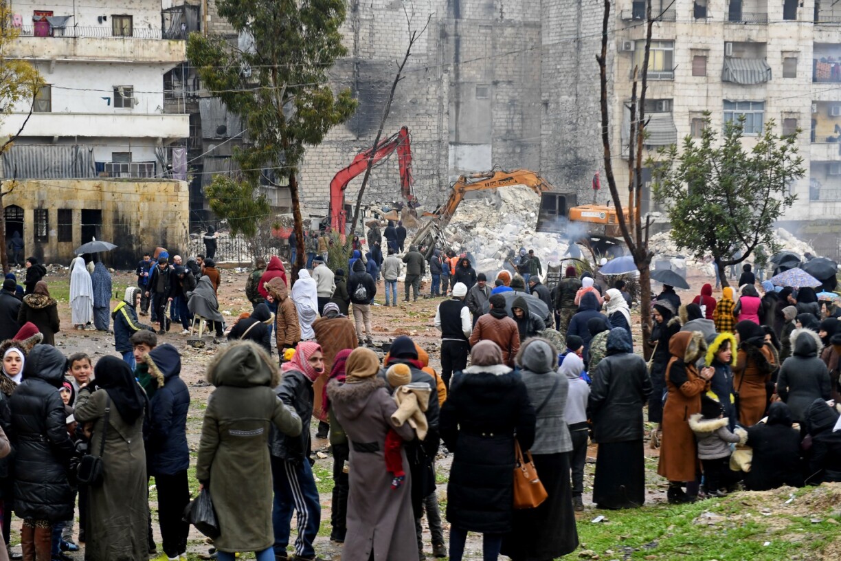 Rescuers search through the rubble of a collapsed building for victims and survivors following a deadly earthquake that shook Syria at dawn on February 6, 2023 in Aleppo's Salaheddine district.