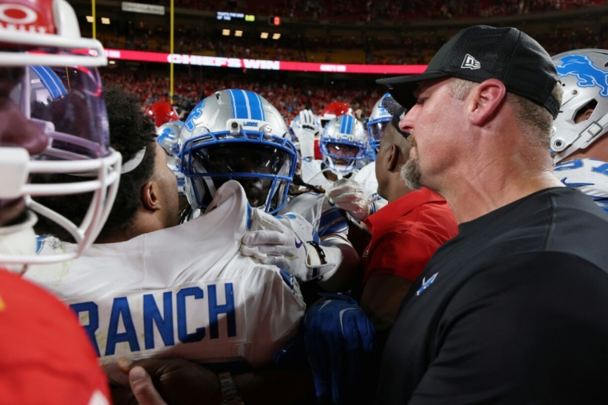 Detroit Lions' safety Brian Branch (L) talks to coach Dan Campbell after a post-game scuffle at Kansas City