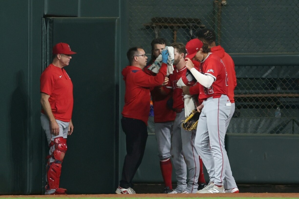 Taylor Ward of the Los Angeles Angels is tended to by medical staff colliding with a scoreboard in the eighth inning of a Major League Baseball game against the Astros in Houston