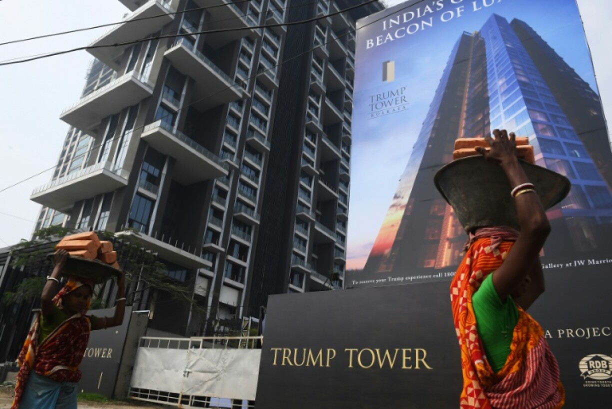 Indian laborers work on the road leading to the under-construction Trump Tower in Kolkata in February 2018
