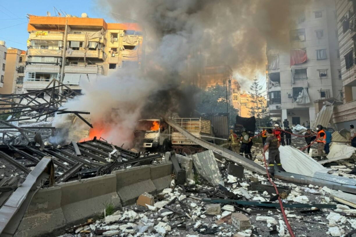 Lebanese firefighters tackle the blaze sparked by an air strike on what Israel said was a Hezbollah missile storage site in south Beirut.