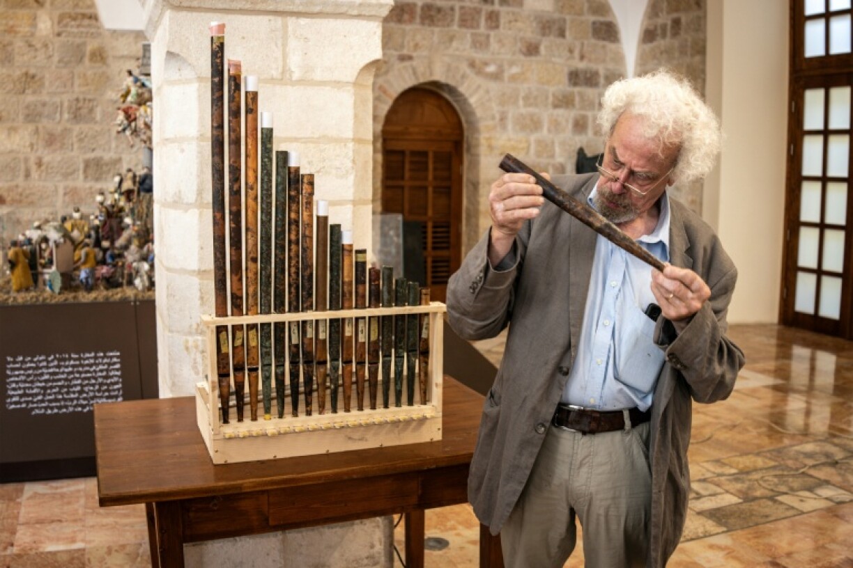 A man inspects a piece of the functioning replica from the oldest organ in Christendom, during the instrument's unveiling at the Saint Saviour's Monastery in the old city of Jerusalem