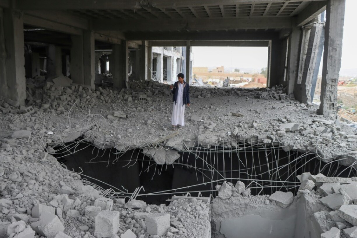 A Yemeni man inspects the damage in the Al-Rasul Al-Aadham cancer and oncology hospital's unfinished building, a day after it was hit in a US strike in Yemen's northern Saada province on March 25, 2025.