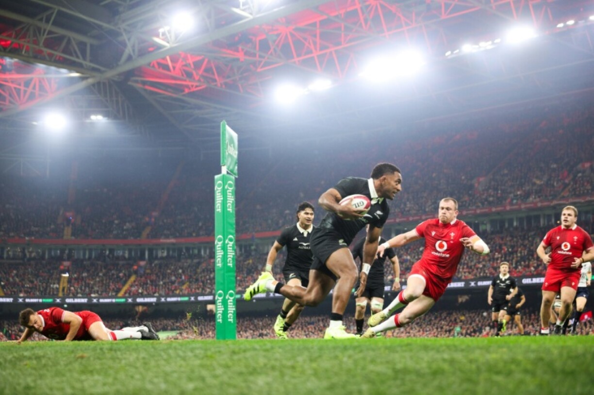 New Zealand's Sevu Reece runs past Wales centre Nick Tompkins to score