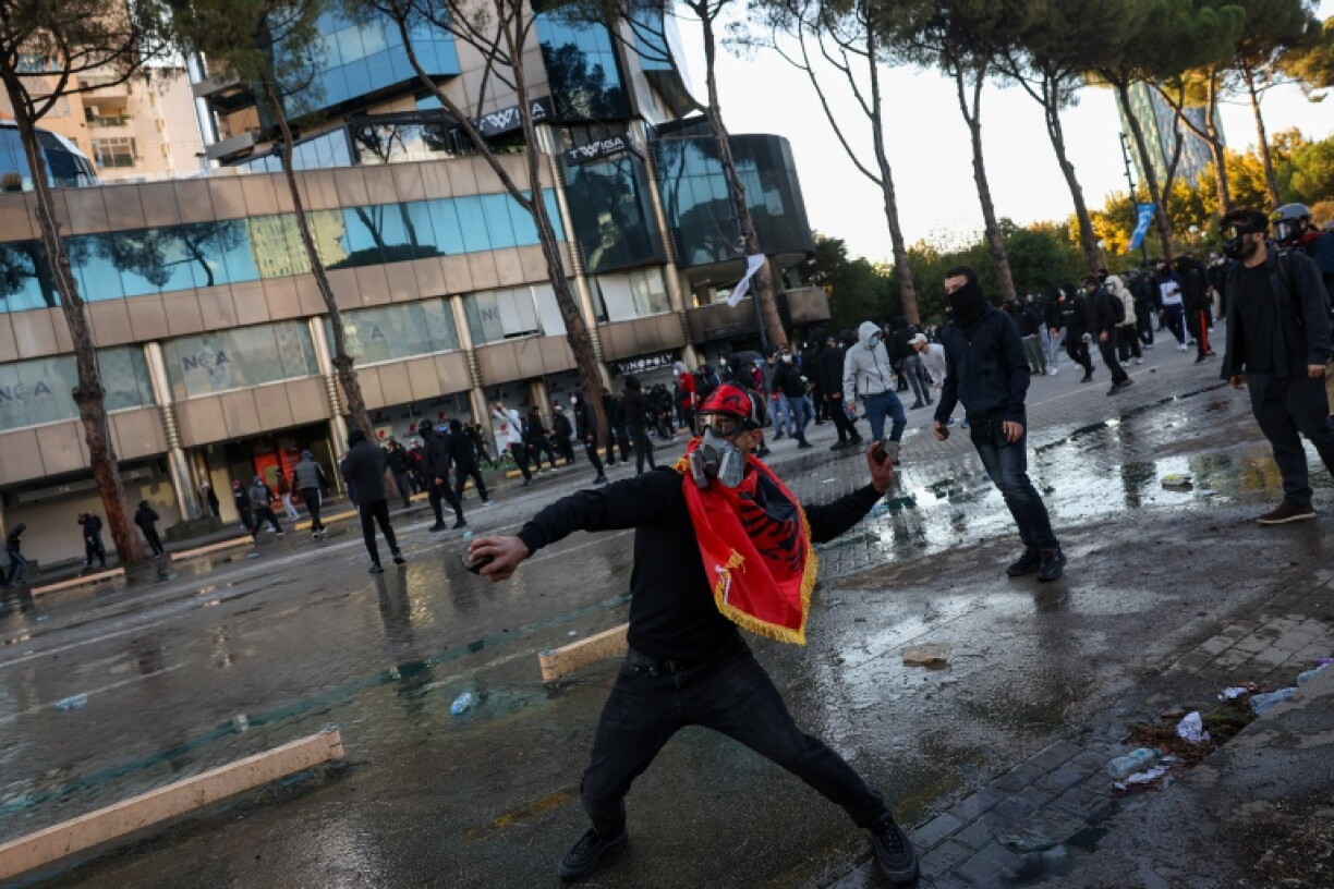 A protester hurls a cobblestone during an anti-government demonstration in Tirana