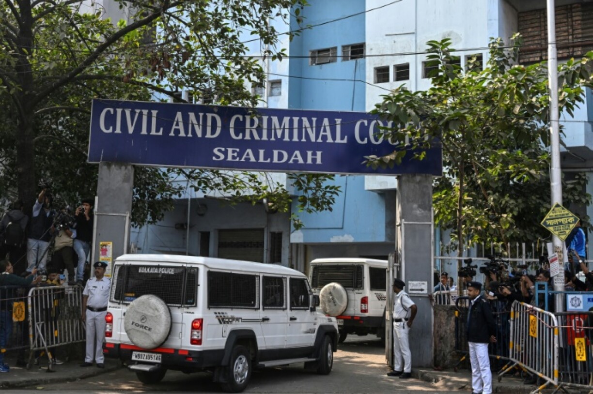 Police stand guard at a Kolkata court's entrance as the man accused of the rape and murder of an Indian doctor arrive