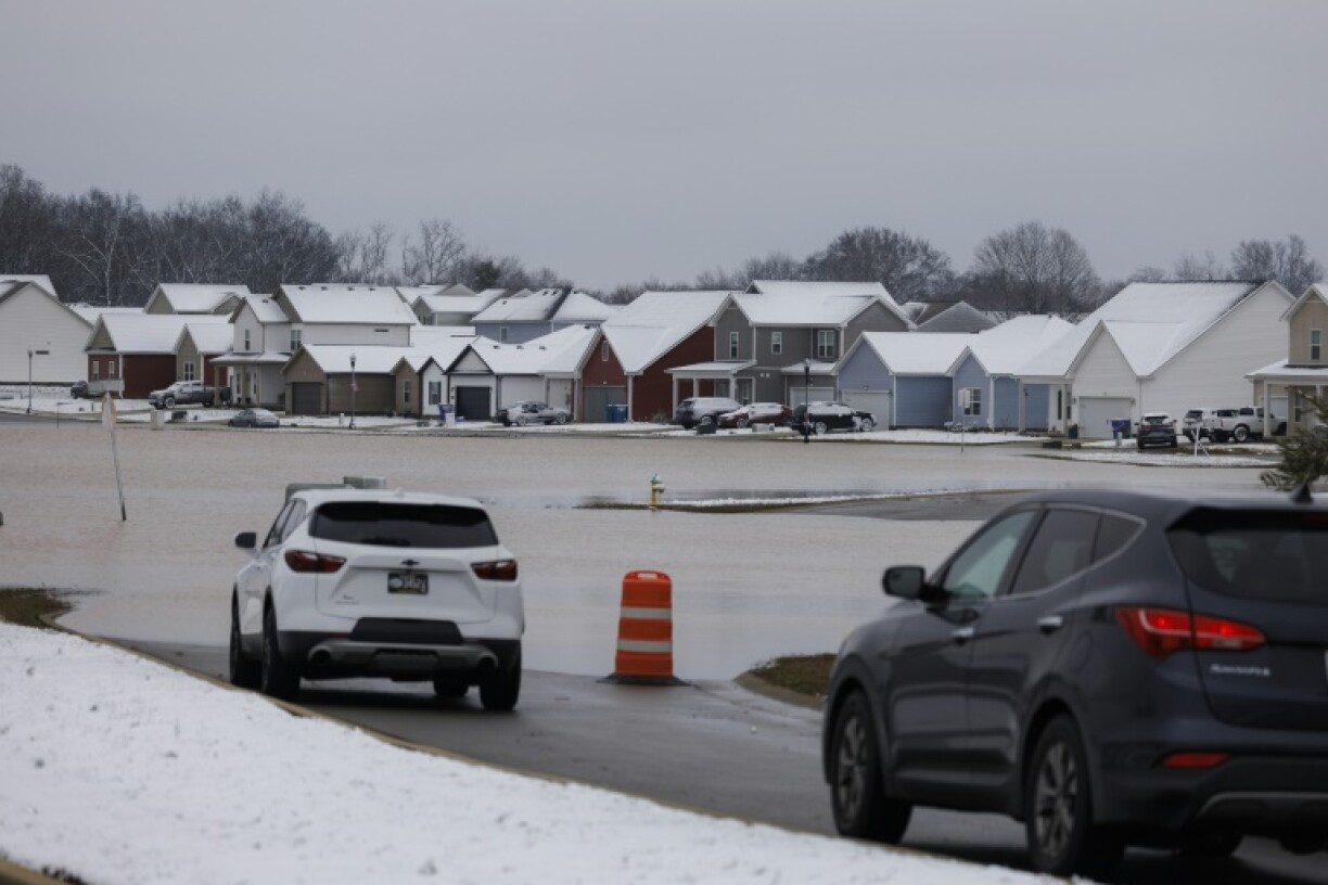 Cars are blocked by flood waters at a housing development outside of Bowling Green in the US state of Kentucky, where severe winter storms led to at least eight deaths