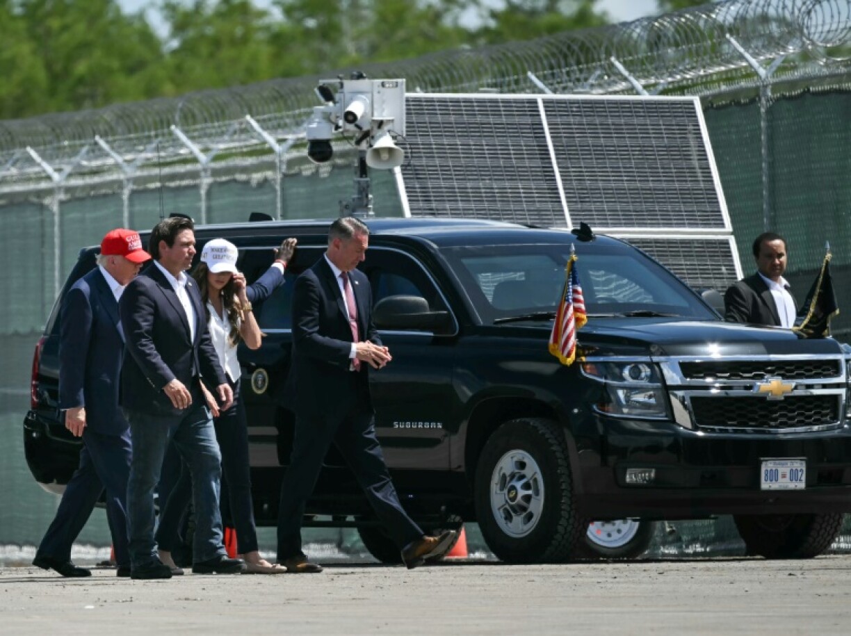 (L/R) US President President Donald Trump, Florida Governor Ron DeSantis, and Secretary of Homeland Security Kristi Noem visit a migrant detention center, dubbed