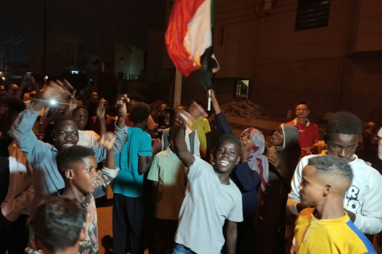 People take to the streets of Port Sudan to celebrate the army's recapture of the capital Khartoum
