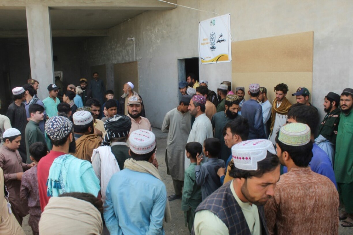 Afghan refugees gather for biometric verification ahead of their departure from Pakistan