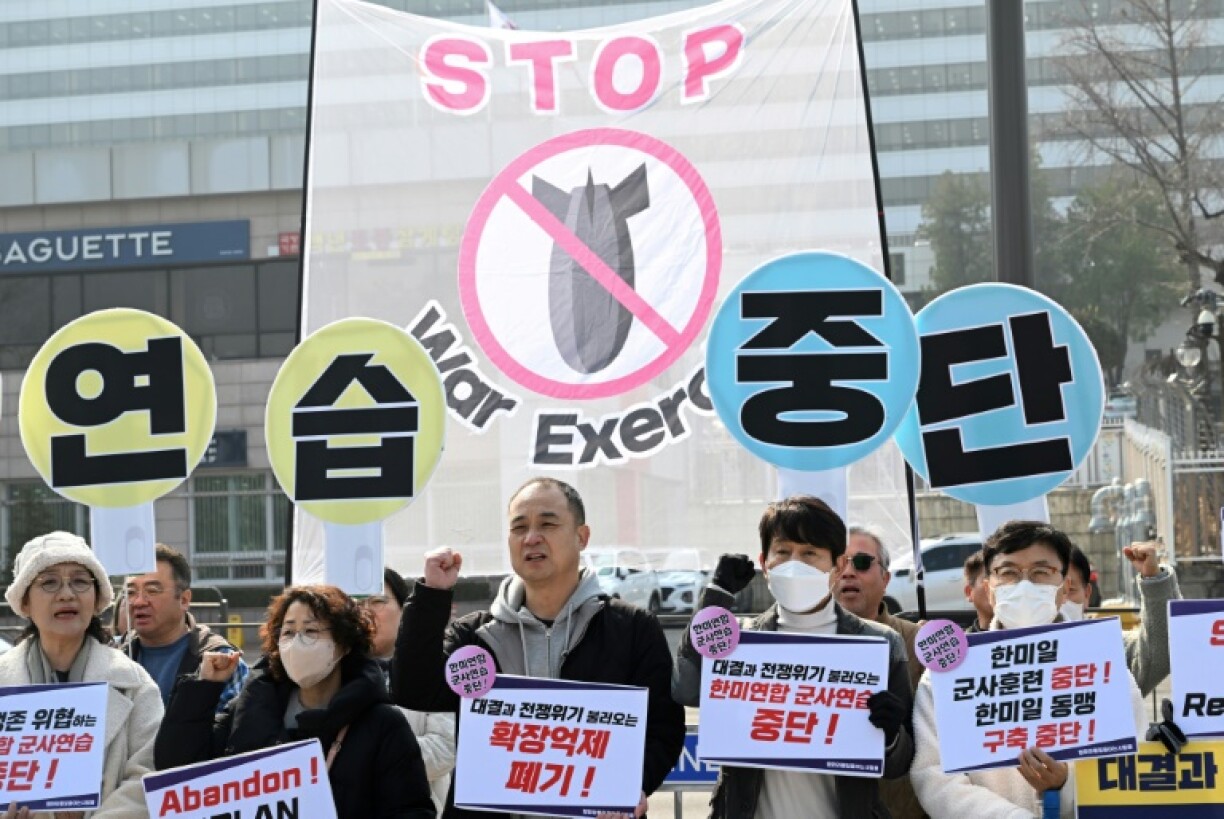 South Korean protesters hold banners that collectively read