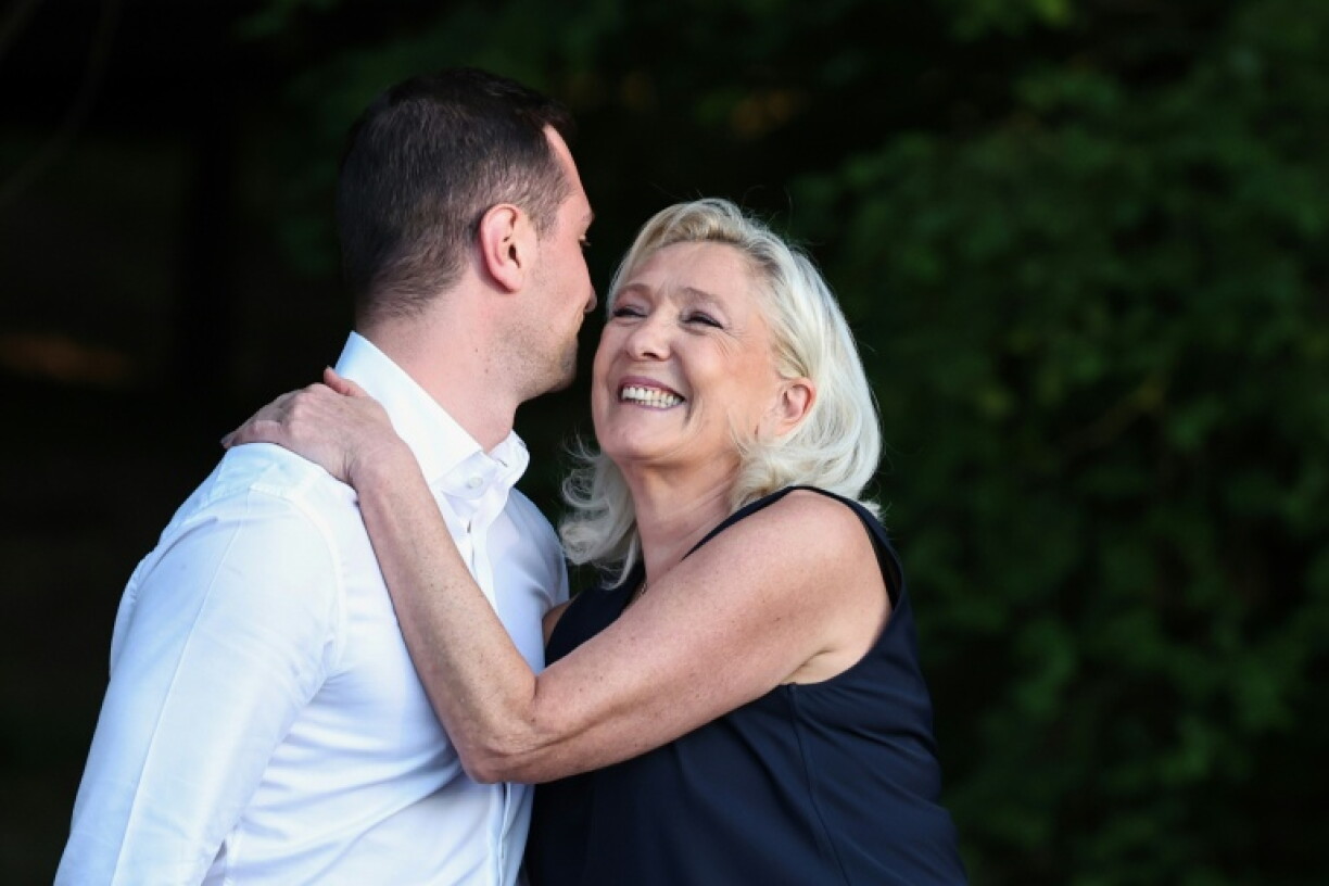 e président du parti d’extrême droite français Rassemblement national (RN), Jordan Bardella (g), et la présidente du groupe parlementaire du Rassemblement national, Marine Le Pen, s’enlacent lors de leur participation à un événement du parti RN, « La fête champêtre », à Liévin, dans le nord de la France, le 4 juillet 2026