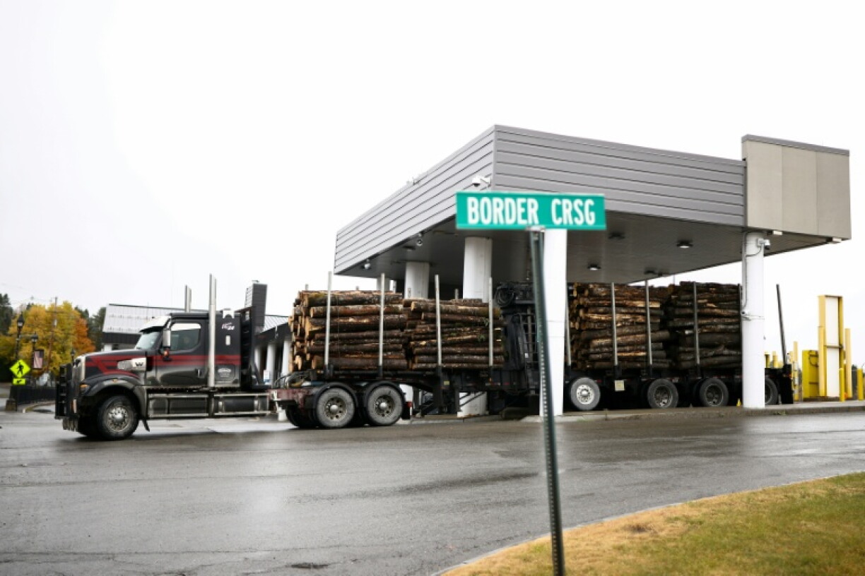 A truck loaded with logs enters the United States from Canada at the border crossing in Fort Kent, Maine, where logging and other industries have been hard hit by US President Donald Trump's tariff policy