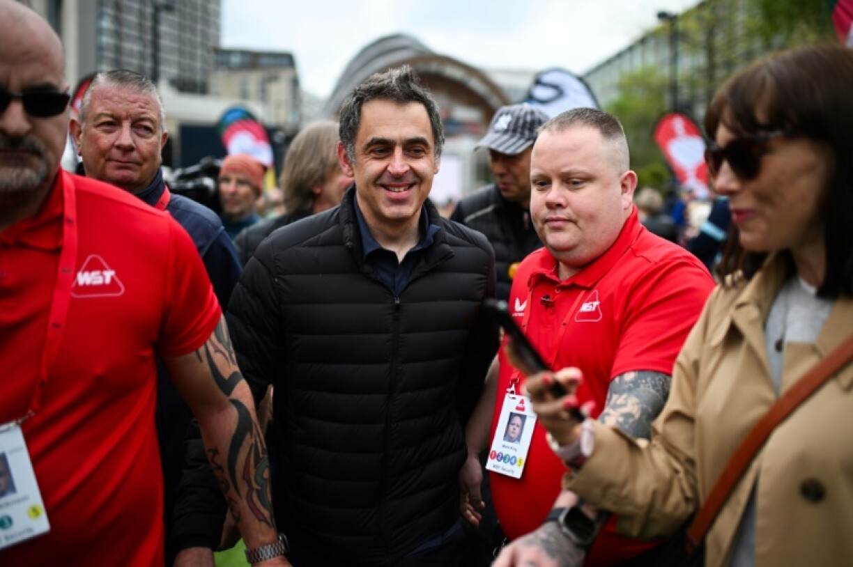 Fans' favourite: Seven-time winner Ronnie O'Sullivan (C) pictured outside the Crucible Theatre, Sheffield, before the start of the 2025 Snooker World Championship