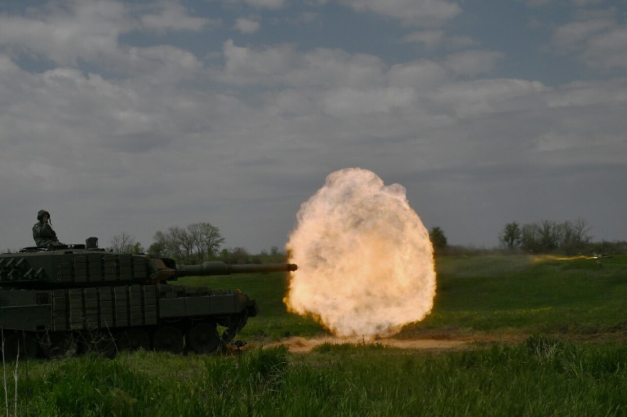 A tank crew of the Ukrainian 33rd Separate Mechanized Brigade fire a round from a Leopard 2A4 tank during a field training exercise at an undisclosed location in Ukraine