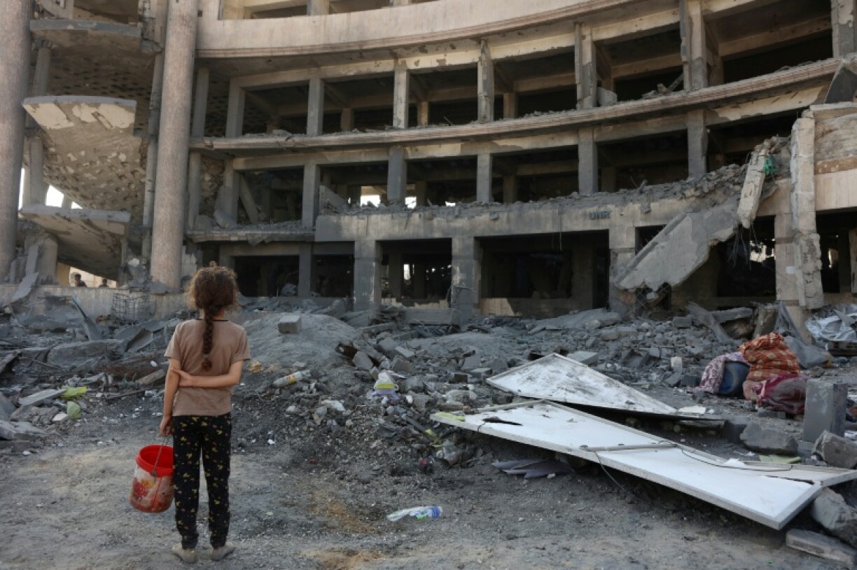 A Palestinian girl at the site of an overnight Israeli strike in Gaza City