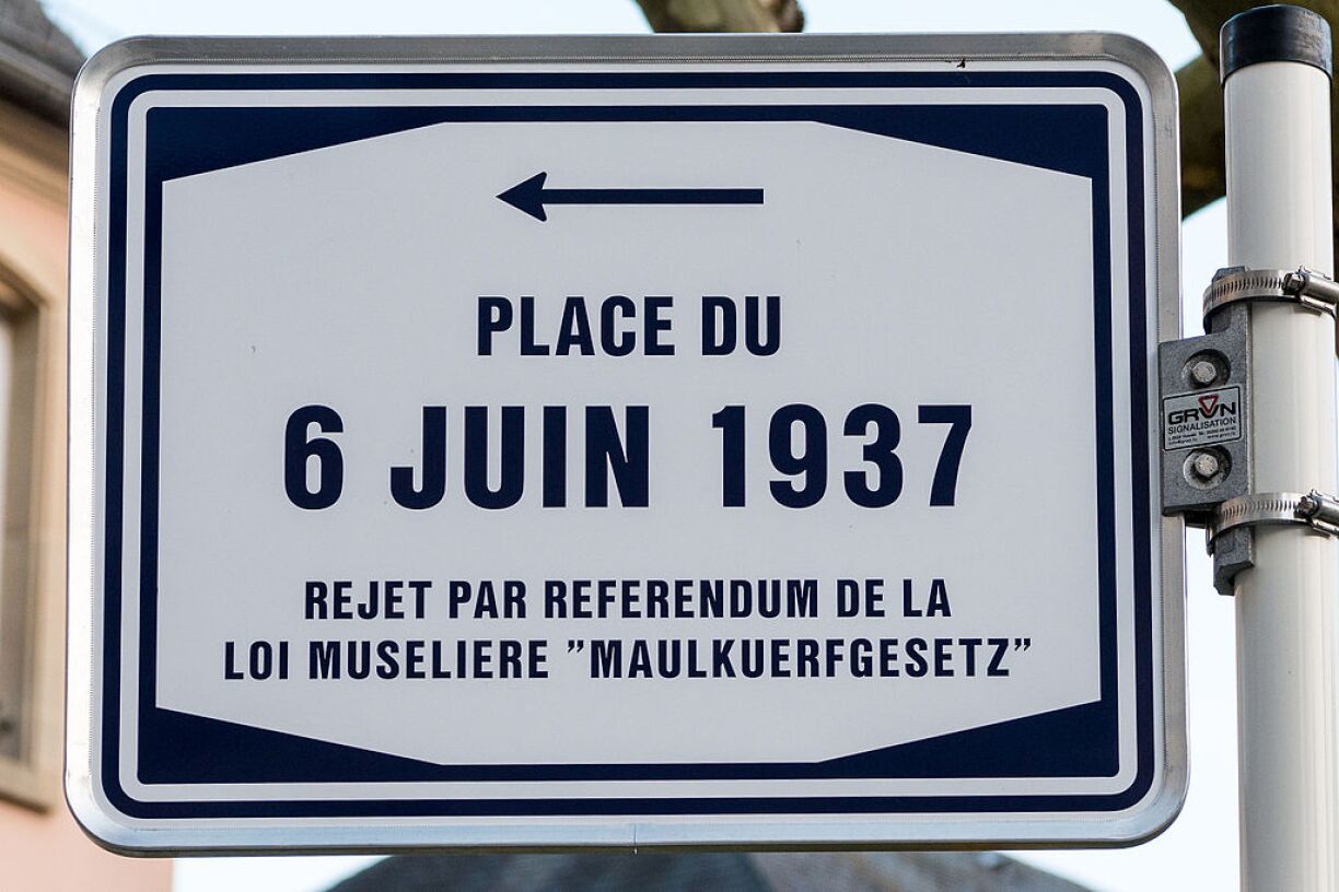 6 June 1937 Square in Luxembourg City. The text reads: Rejection through referendum of the Maulkuerfgesetz Muzzle Law.