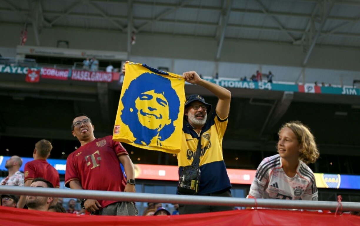 A soccer fan waves a flag with the image of late Argentine football legend Diego Maradona