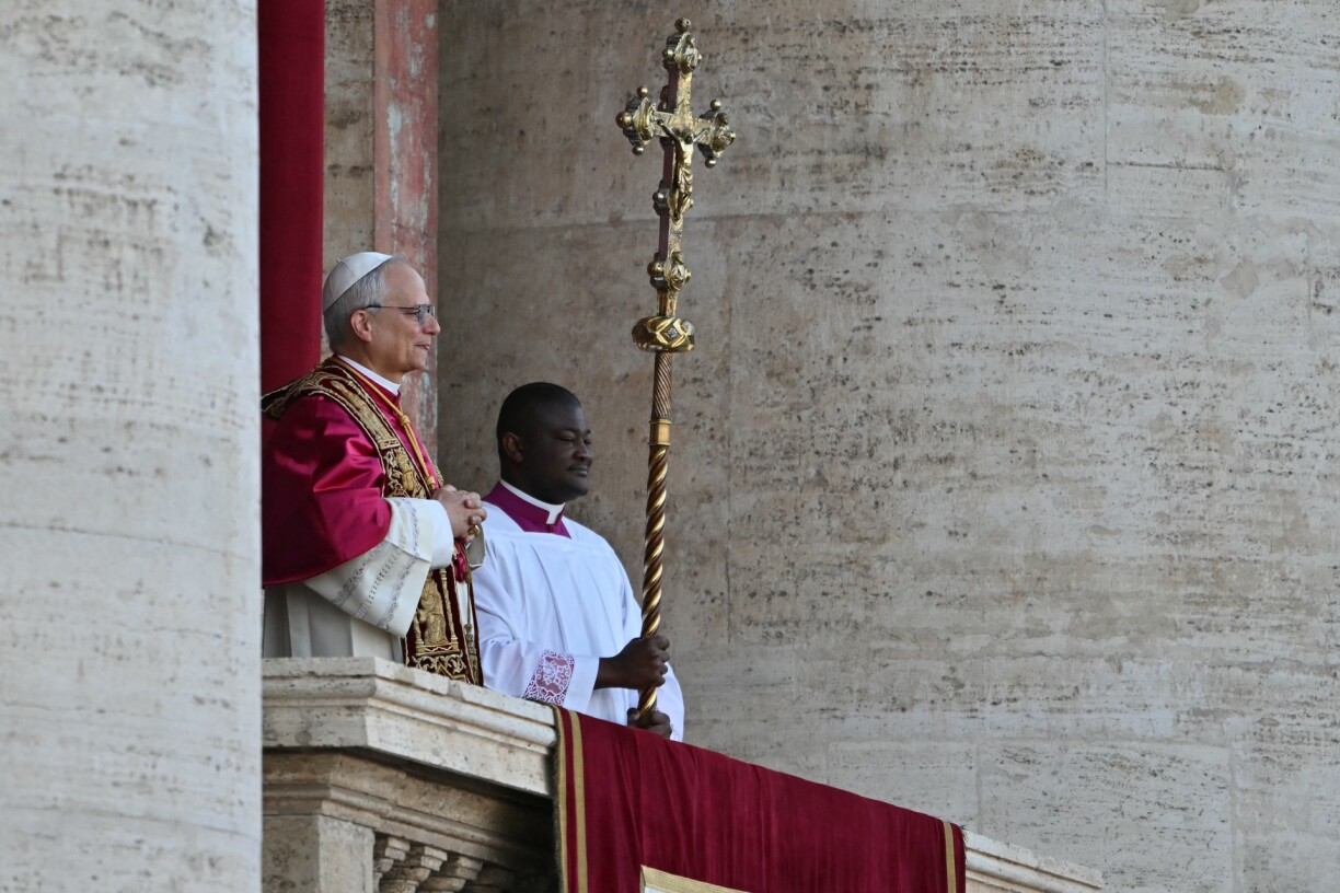 Newly elected Pope Robert Francis Prevost arrives on the main central loggia balcony of the St Peter's Basilica for the first time, after the cardinals ended the conclave, in The Vatican, on May 8, 2025. Robert Francis Prevost was on Thursday elected the first pope from the United States, the Vatican announced. A moderate who was close to Pope Francis and spent years as a missionary in Peru, he becomes the Catholic Church's 267th pontiff, taking the papal name Leo XIV.