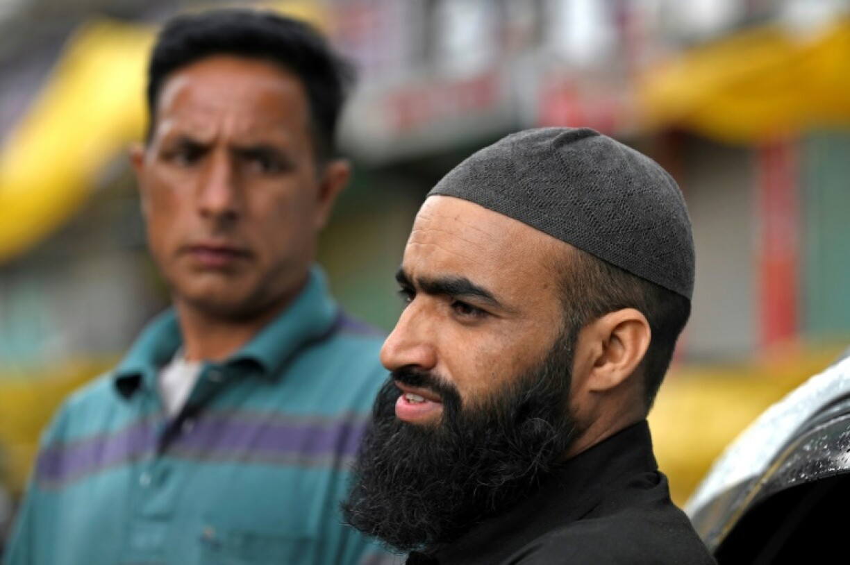 Basharat Hussain (R) bundled his family of five in a car to return to their house