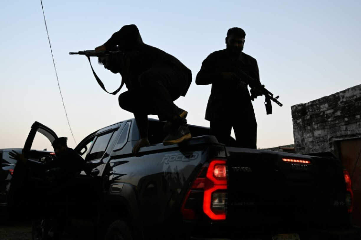 Private security personnel working for politician Ali Warraich, disembark from their Hilux