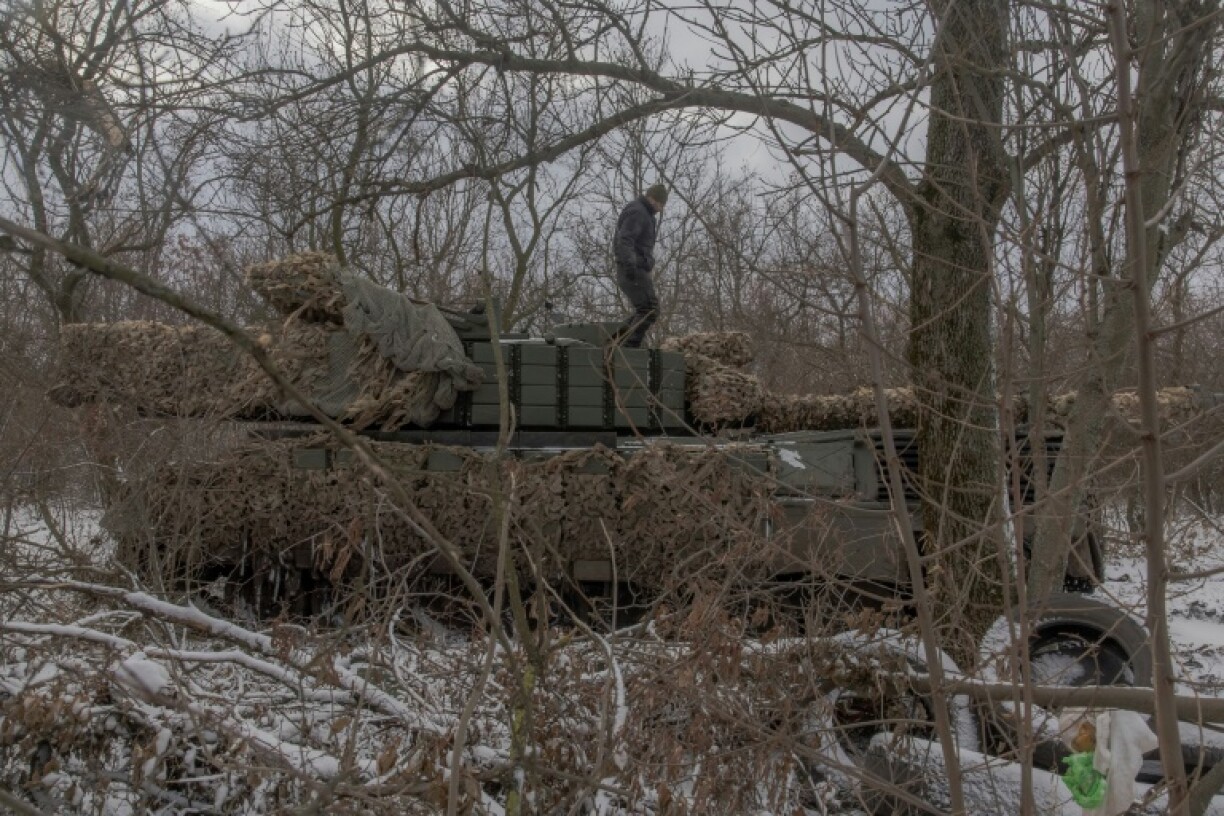 A Ukrainian tank crew member of the 68th Jaeger Brigade stands on a Leopard 1A5 tank near Pokrovsk