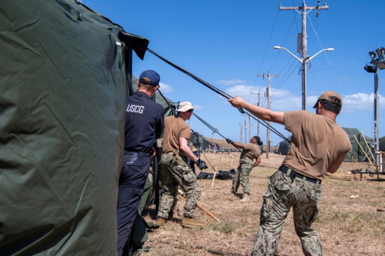 American personnel erect tents for migrant detention operations at the US military base at Guantanamo Bay, Cuba
