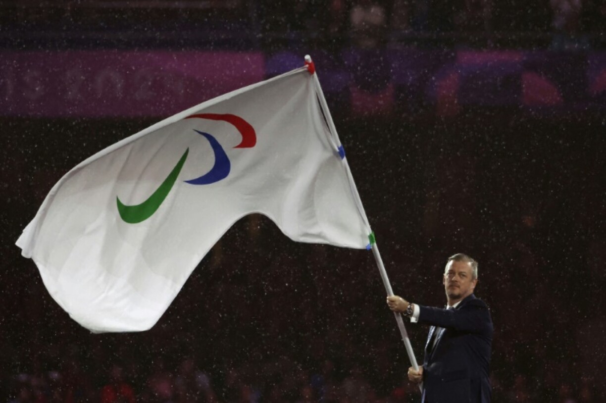 International Paralympic Committee president Andrew Parsons waves the movement's flag at the closing ceremony of the 2024 Summer Paralympics in Paris