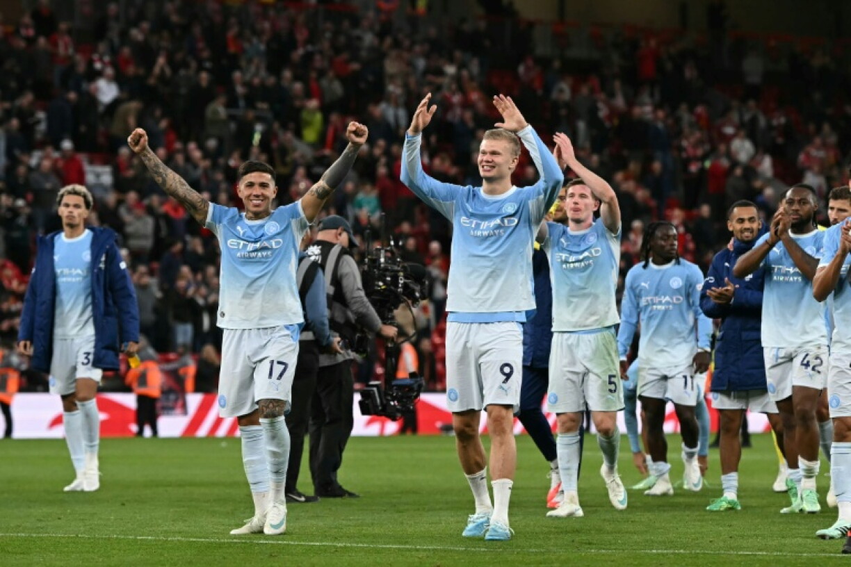 Manchester City celebrate their 3-0 win against Liverpool at Anfield