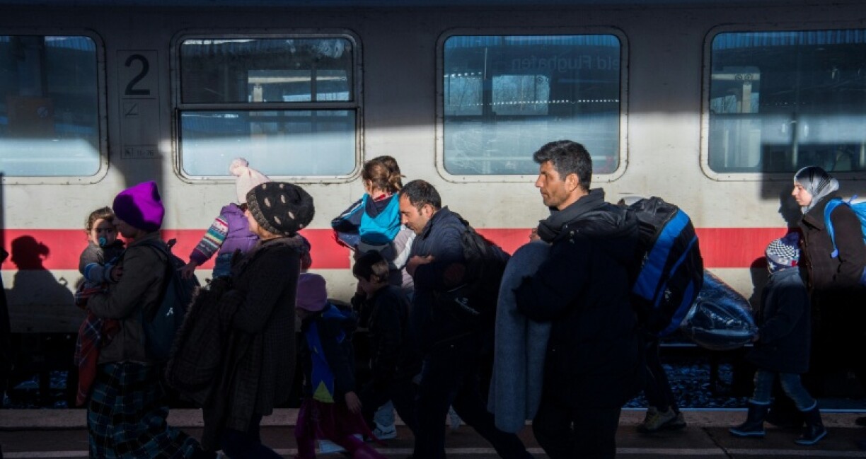 Asylum seekers arrive on a train to Brandenburg in 2015