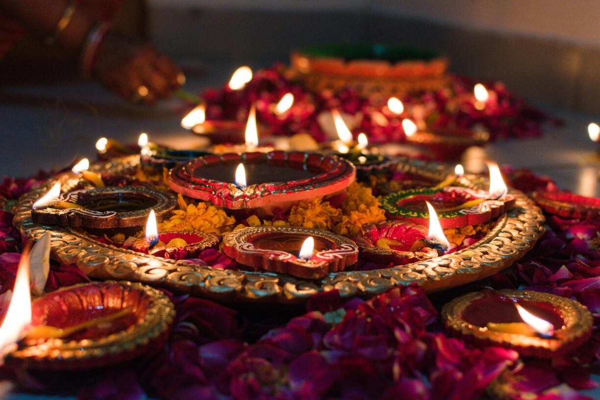 Combination of diyas and candles laid out for Diwali.