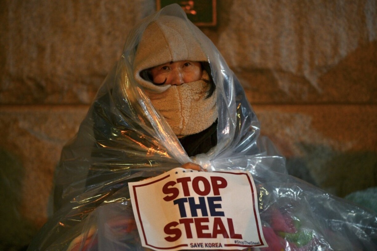A supporter of impeached South Korea's president Yoon Suk Yeol attends a rally near his residence in Seoul