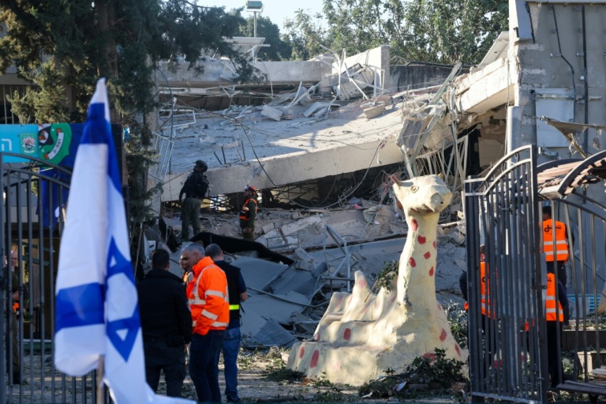 Emergency services personnel inspect the rubble of a destroyed school building in Ramat Gan, near Tel Aviv, after Yemeni rebels fired a missile