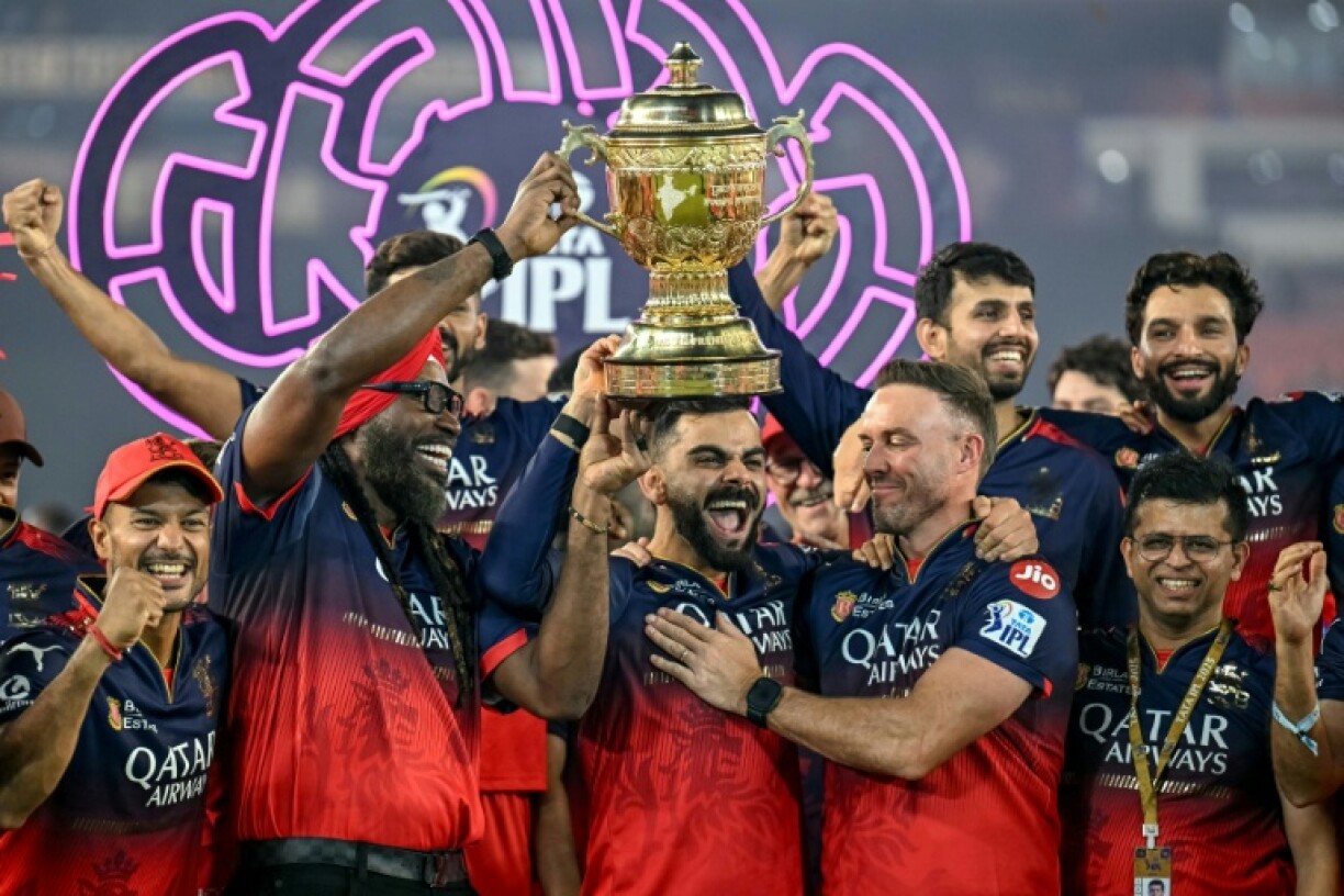 Royal Challengers Bengaluru's Virat Kohli (centre) and teammates celebrate the team's IPL final victory in June this year