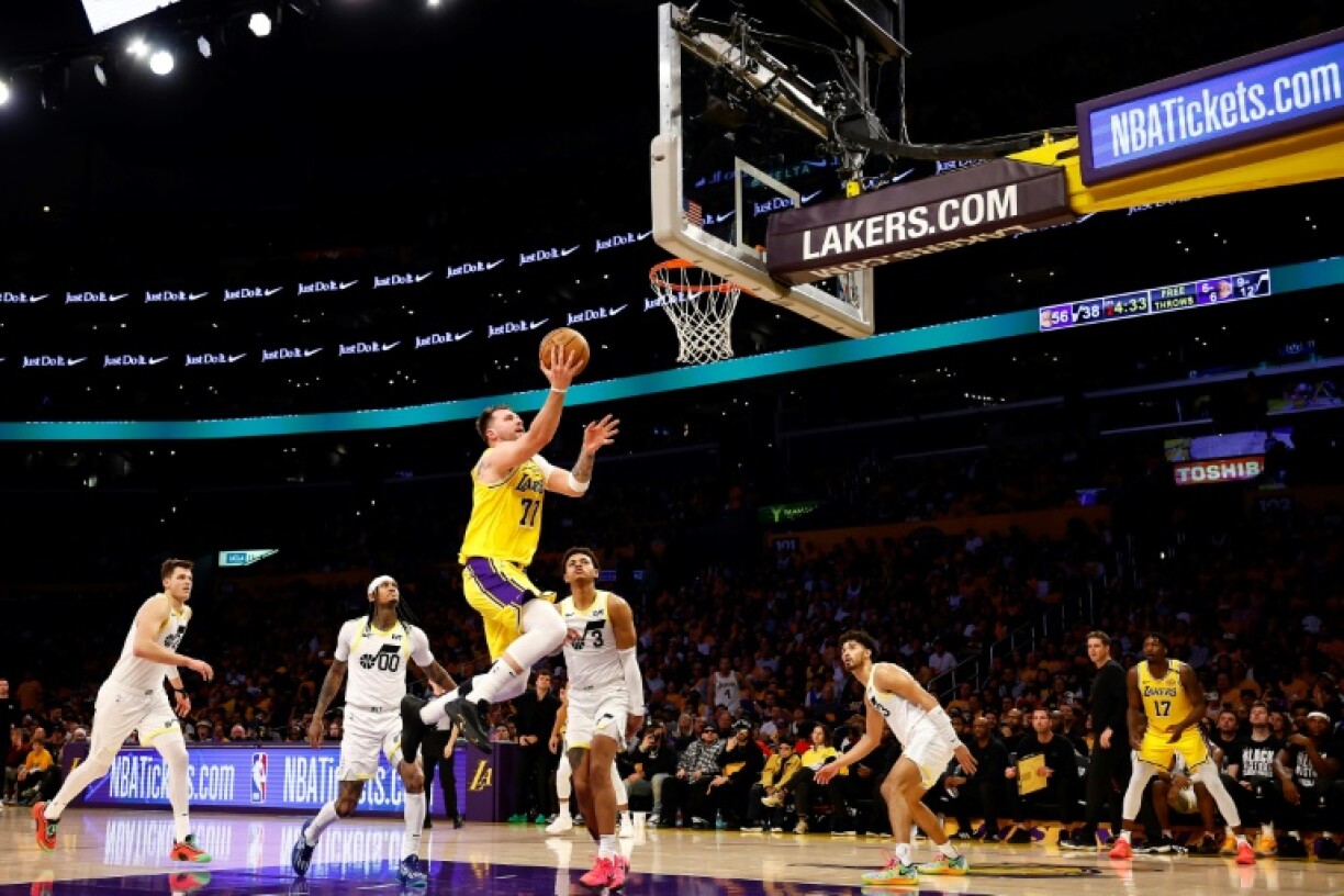 Luka Doncic drives to the basket during a winning debut for the Los Angeles Lakers