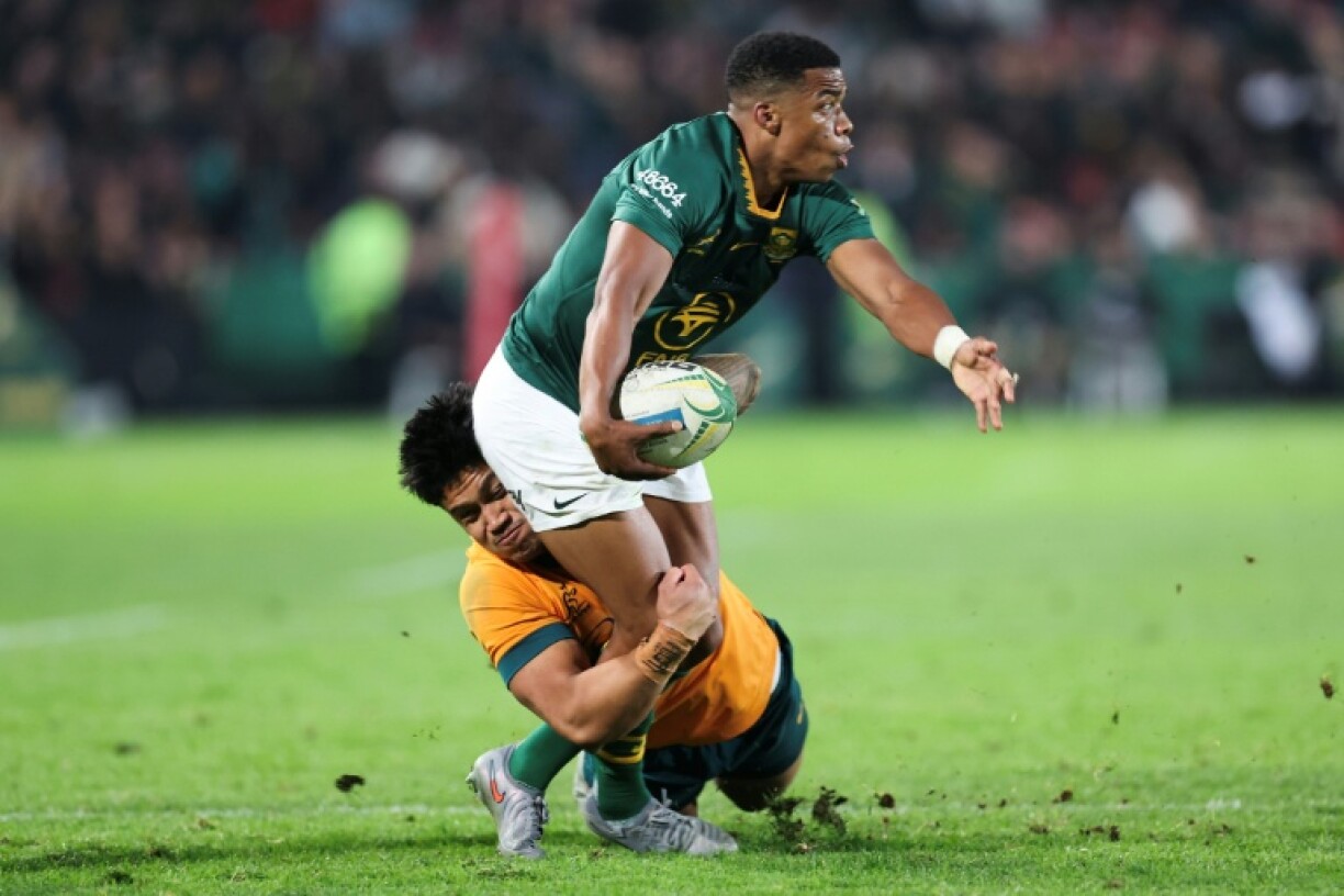 South Africa scrum-half Grant Williams (R) is tackled by Australia centre Len Ikitau in Johannesburg.