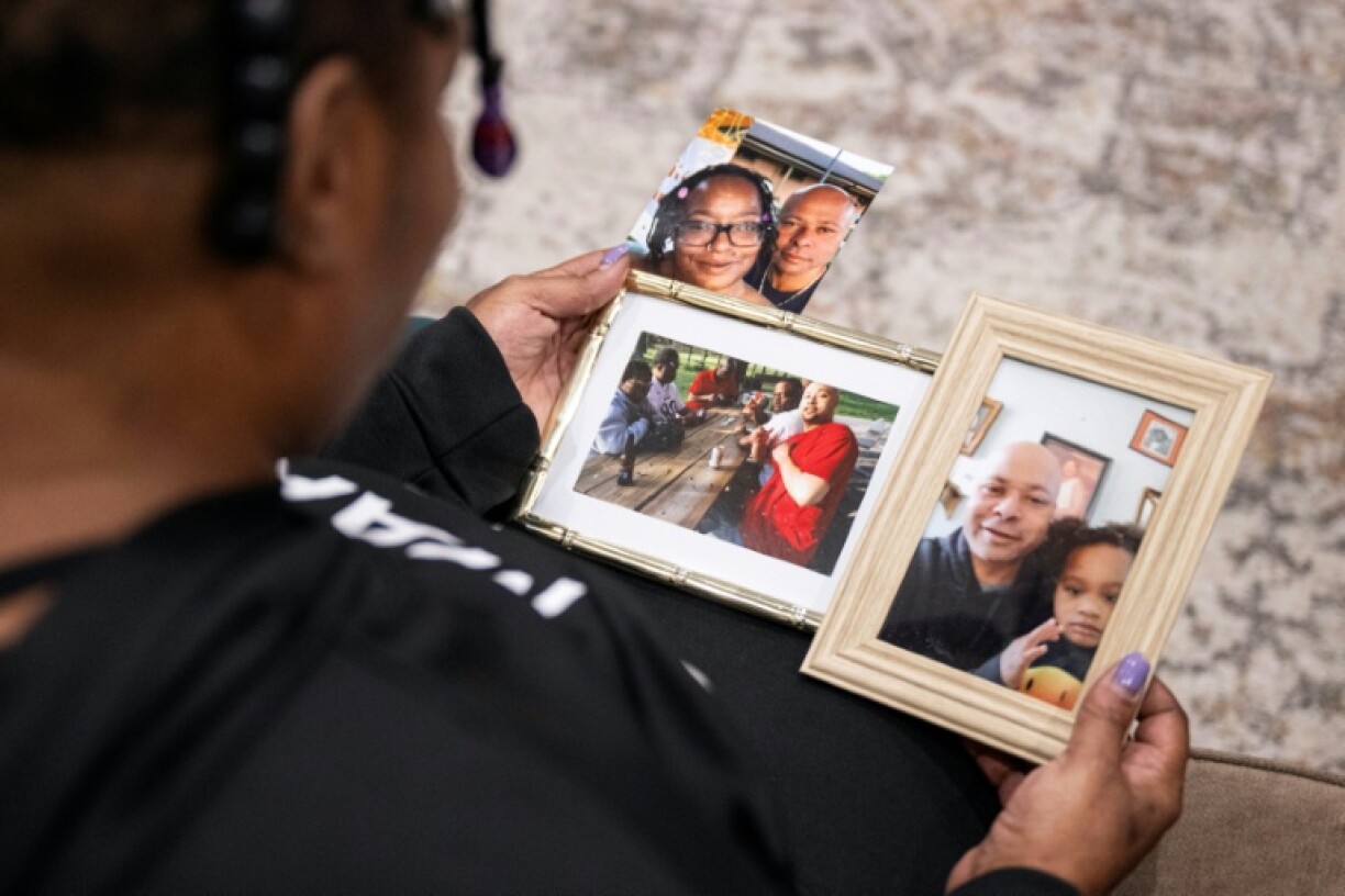 Stephanie Fairweather looks at pictures of her late brother Denton Loudermill Jr. in Olathe, Kansas, on November 12, 2025
