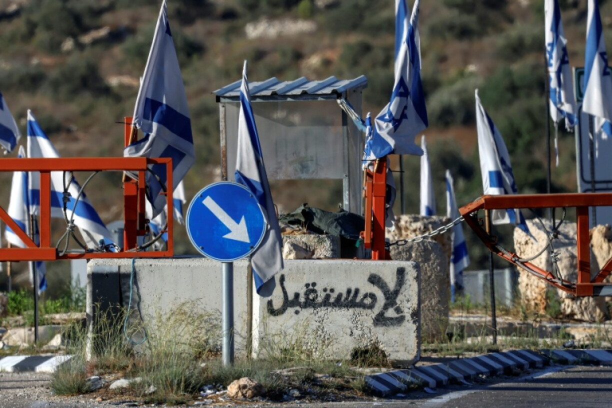 Graffiti reading "no future" in Arabic is depicted on a concrete block at the closed vehicle barrier of the Ein Sinya checkpoint at the northern entrance of Ramallah